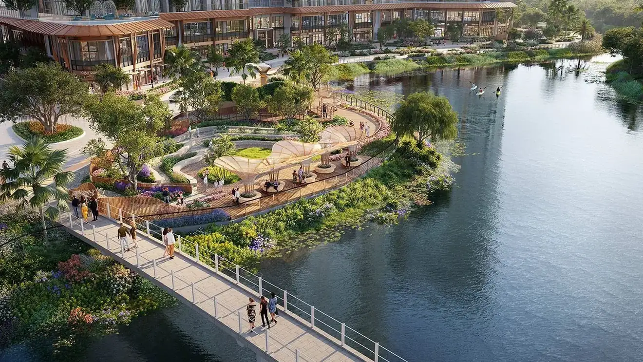 The garden island. A planted island reached by footbridge, at the turn of the water.