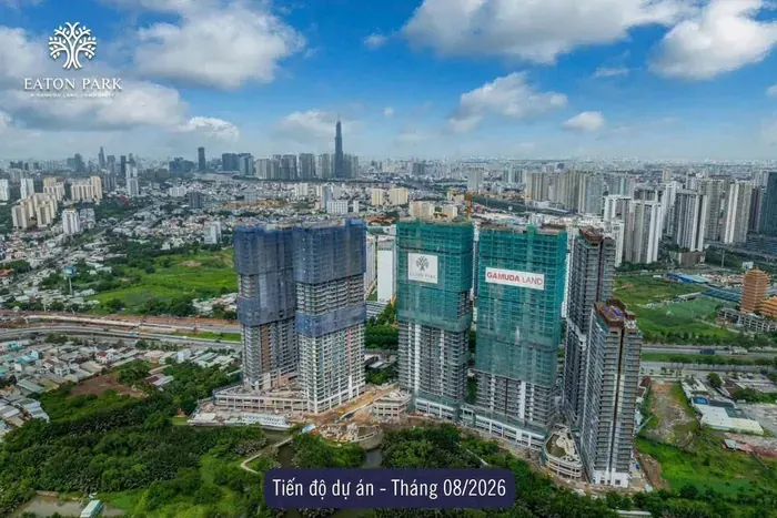 Ảnh chụp tiến độ Eaton Park từ trên cao, tháng 8 năm 2026. Cả sáu tòa tháp đã đạt chiều cao thiết kế, lưới bao che đang tháo dần ở các tầng dưới, lộ mặt dựng và ban công, khối đế và cảnh quan đã định hình.